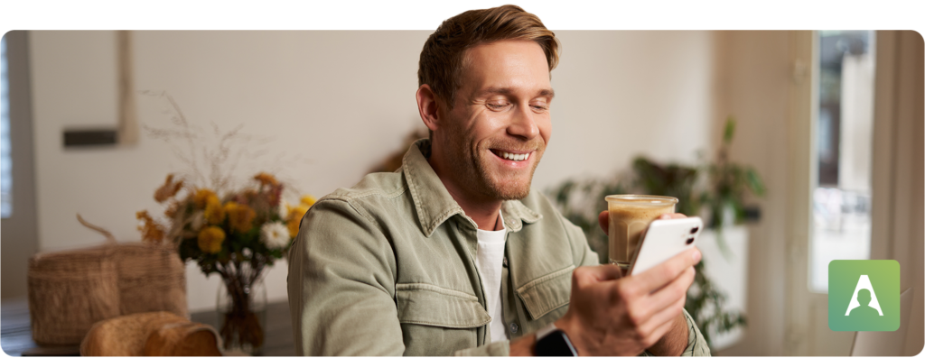 man on phone drinking iced coffee